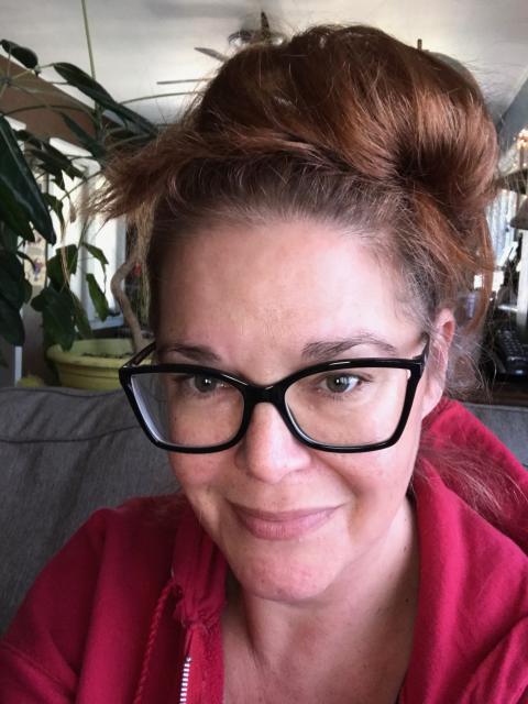 Jiffy Lansing headshot, a woman with brown hair, styled up and dark rimmed glasses.